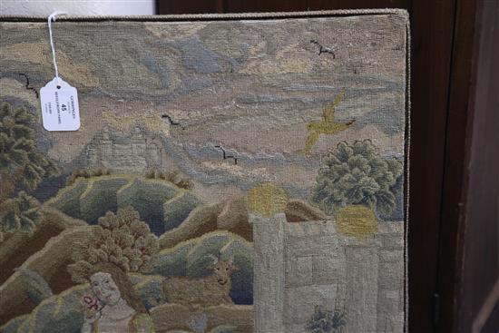 An 18th century needlework panel depicting a shepherdess in a landscape, 26.5 x 22in.